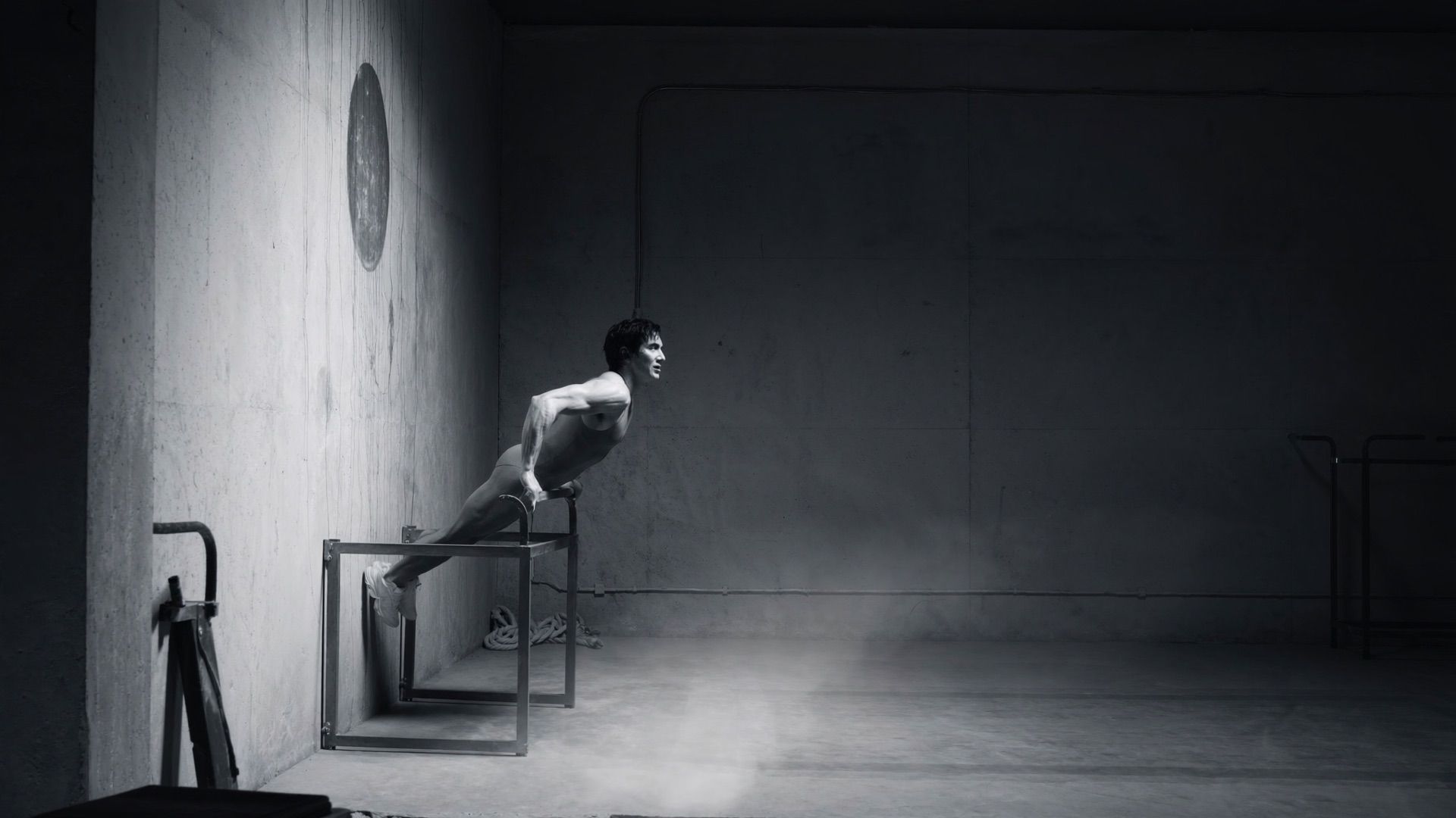 Athlete in motion in a concrete studio.